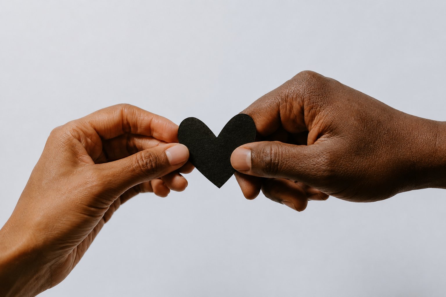 Two hands holding a heart